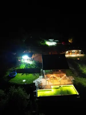 a night view of a building with lights on it at Green Sea Resort - Zeleno More in Visoko