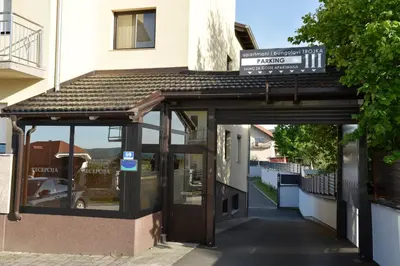an entrance to a building with a sign on it at Apartmani i Bungalovi TROJKA in Banja Luka