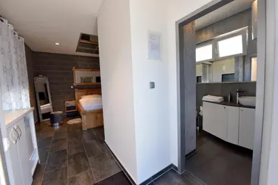 a room with a bathroom with a sink and a counter at Apartmani i Bungalovi TROJKA in Banja Luka