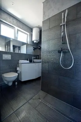 a bathroom with a toilet and a shower in it at Apartmani i Bungalovi TROJKA in Banja Luka