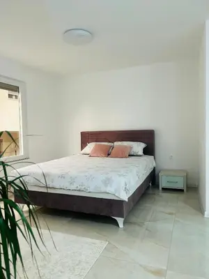 a bedroom with a bed with two pillows on it at Apartman Zen in Bihać