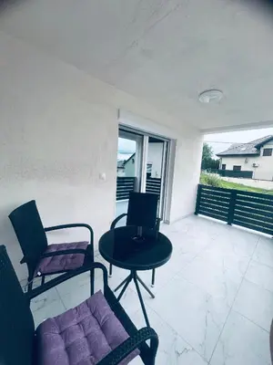 a room with two chairs and a table on a patio at Apartman Zen in Bihać
