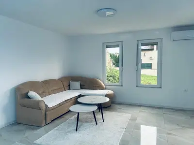 a living room with a couch and a table at Apartman Zen in Bihać