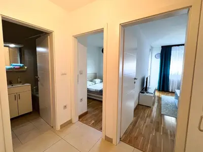 a room with two doors leading to a bedroom at stan na dan Tivana Doboj in Doboj
