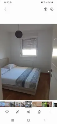 a bedroom with a bed and a window at stan na dan Tivana Doboj in Doboj