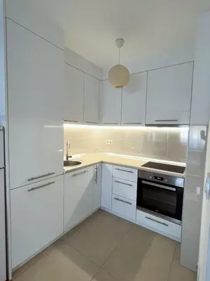 a white kitchen with white cabinets and a sink at stan na dan Tivana Doboj in Doboj