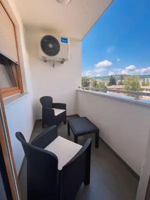 a balcony with chairs and a table and a window at stan na dan Tivana Doboj in Doboj
