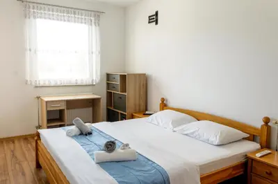 a bedroom with a bed with towels on it at Apartman Rest 'n' Go in Doboj