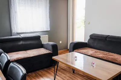 a living room with two couches and a coffee table at Apartman Rest 'n' Go in Doboj