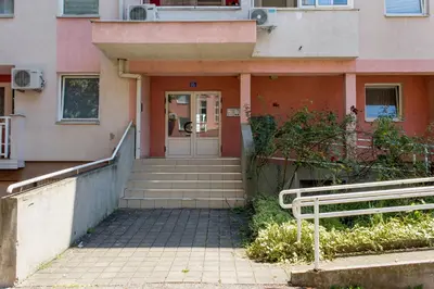 a house with stairs leading up to a door at Apartman Rest 'n' Go in Doboj