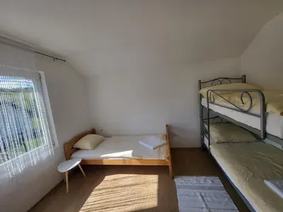 a small room with two bunk beds and a window at Kuća za odmor PLAVA LAGUNA in Bihać