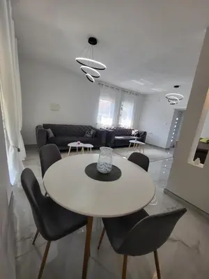 a white table and chairs in a living room at Kuća za odmor PLAVA LAGUNA in Bihać