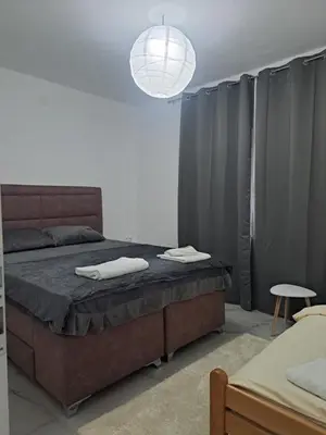 a bedroom with a bed with two towels on it at Kuća za odmor PLAVA LAGUNA in Bihać