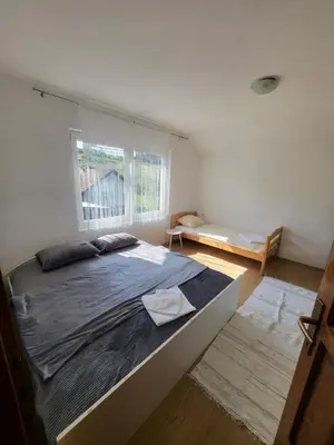 a bedroom with a large bed and a window at Kuća za odmor PLAVA LAGUNA in Bihać
