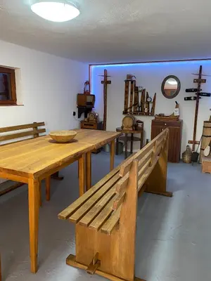 a room with a wooden bench and a table at Vikendica Lucija in Livno