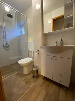a bathroom with a toilet and a sink and a shower at Vikendica Lucija in Livno