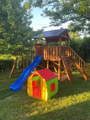 a wooden playground with a slide and a play structure at Vikendica Lucija in Livno