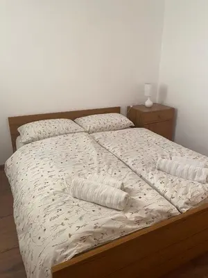 a bed with two pillows on it in a bedroom at Vikendica Lucija in Livno