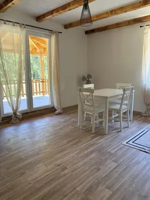 a dining room with a white table and chairs at Ranch Jajce in Jezero