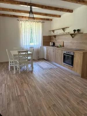 a kitchen and dining room with a table and chairs at Ranch Jajce in Jezero