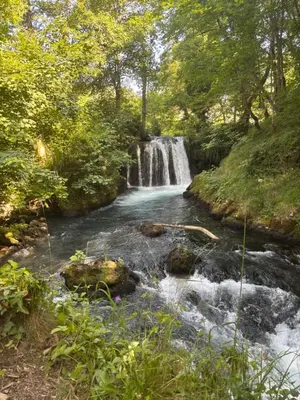 a waterfall in the middle of a river at Ranch Jajce in Jezero