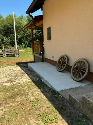 a building with two large woodenoked wheels on the side of it at Ranch Jajce in Jezero