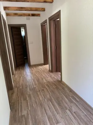 a hallway of a house with wooden floors and doors at Ranch Jajce in Jezero