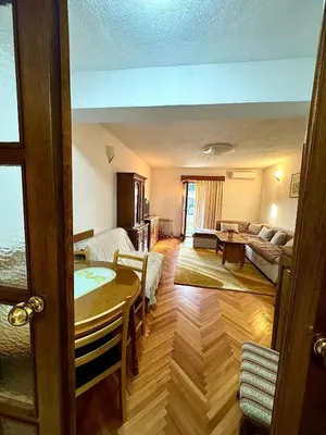 a living room with a table and a couch at Harmonija - Trn, Banjaluka in Laktaši