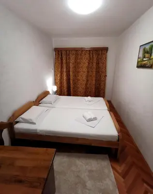 a small bedroom with a bed and a window at Harmonija - Trn, Banjaluka in Laktaši
