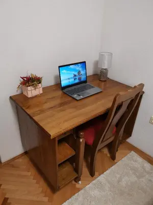 a laptop computer sitting on top of a wooden desk at Harmonija - Trn, Banjaluka in Laktaši