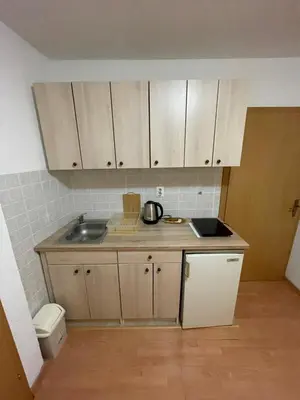 a small kitchen with a sink and a counter at Apartmani Centar Fojnica in Fojnica