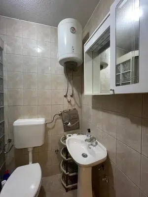 a small bathroom with a toilet and a sink at Apartmani Centar Fojnica in Fojnica
