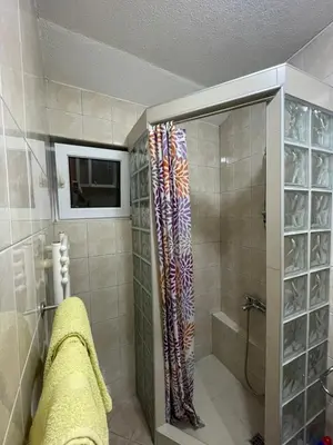 a bathroom with a shower with a shower curtain at Apartmani Centar Fojnica in Fojnica