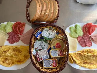a basket of breakfast food with eggs meat and cheese at Sobe Dado, Gostionica Kod Dade in Banja Luka