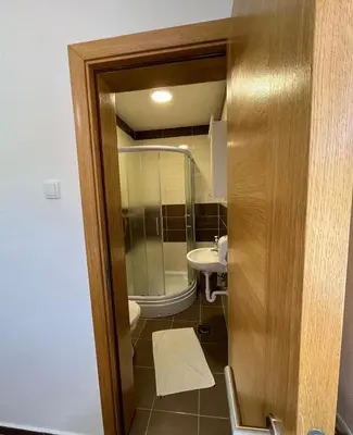 a small bathroom with a toilet and a sink at Sobe Dado, Gostionica Kod Dade in Banja Luka