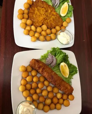 two plates of food with tater tots and fish on them at Sobe Dado, Gostionica Kod Dade in Banja Luka