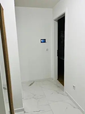 a hallway with a white wall and a door at LookView apartment in Bihać