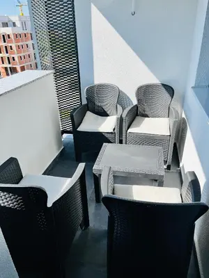 a group of chairs and tables on a balcony at LookView apartment in Bihać