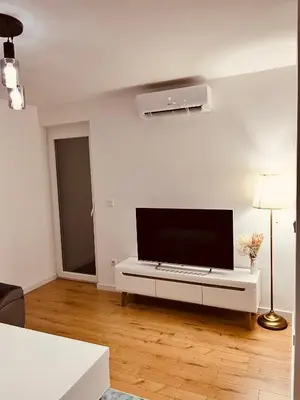 a living room with a flat screen tv on a wall at LookView apartment in Bihać