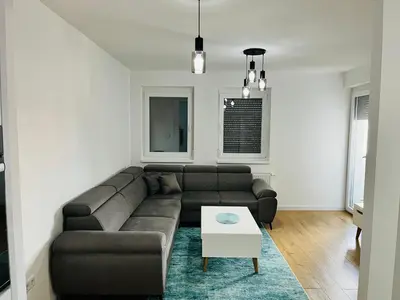 a living room with a couch and a table at LookView apartment in Bihać