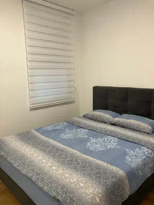 two twin beds in a room with a window at Apartman City Centar Banjaluka in Banja Luka