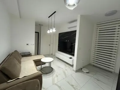 a living room with a couch and a table at Apartman City Centar Banjaluka in Banja Luka