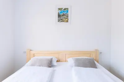 two beds in a bedroom with white walls at BDD House in Banja Luka