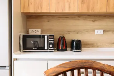 a microwave sitting on top of a counter at BDD House in Banja Luka