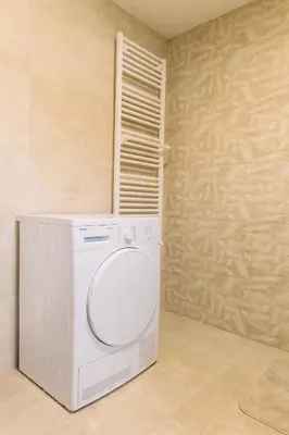 a white washer and dryer in a room at BDD House in Banja Luka