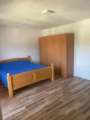 a bedroom with a bed and a wooden cabinet at Vidovdanska house in Šipovo