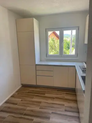 an empty kitchen with a window on the wall at Vidovdanska house in Šipovo