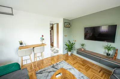 a living room with a large flat screen tv on the wall at Šarmantan stan u centru grada in Banja Luka
