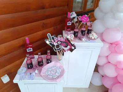 a table with pink and white balloons and bottles of wine at Brvnara Gold Hill in Prijedor