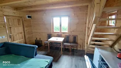 a room with a table and chairs in a log cabin at Brvnara Gold Hill in Prijedor